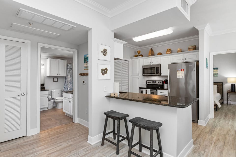Your open kitchen features granite counters, stainless appliances, and breakfast bar seating—perfect for morning coffee or casual meals together.