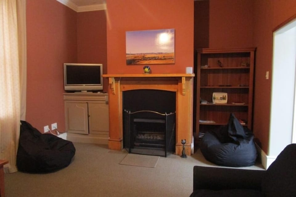 Gas fireplace supplements cosy warmth from wall heaters throughout cottage