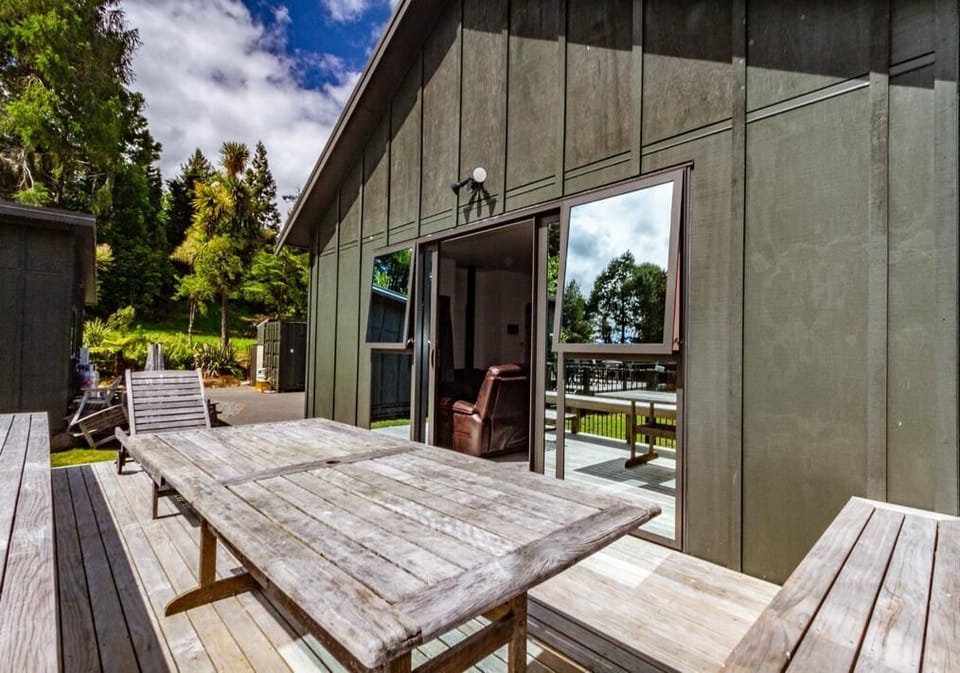 Dining lounge opens onto a deck with beautiful views of a reserve 