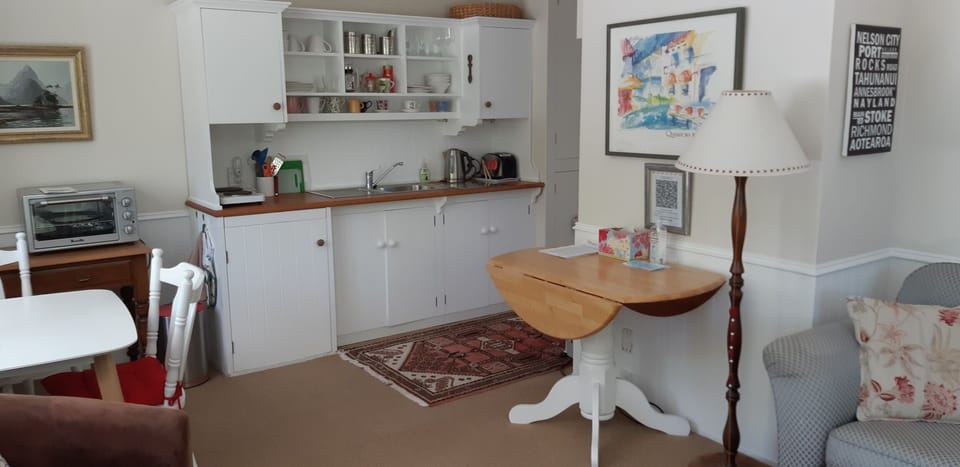 Kitchen area with underbench fridge and microwave and double cooking hob