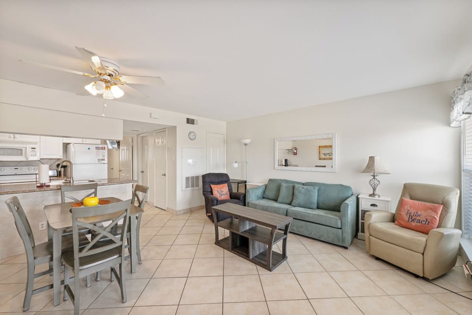 Your bright, airy living space features comfortable seating and an open kitchen, perfect for relaxing after beach days.