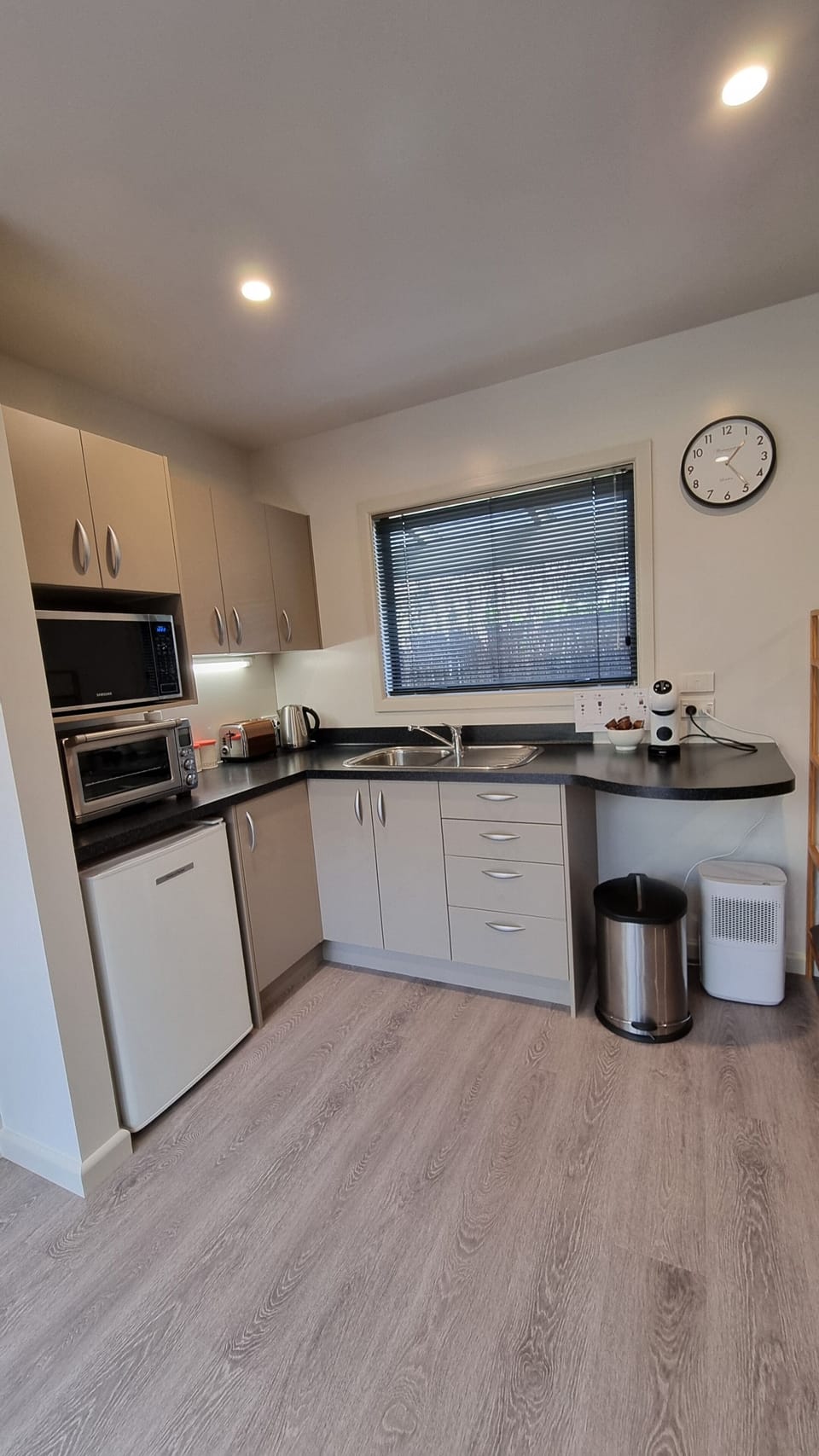 Kitchen has microwave, bench top oven, coffee machine, bench top hot plate.