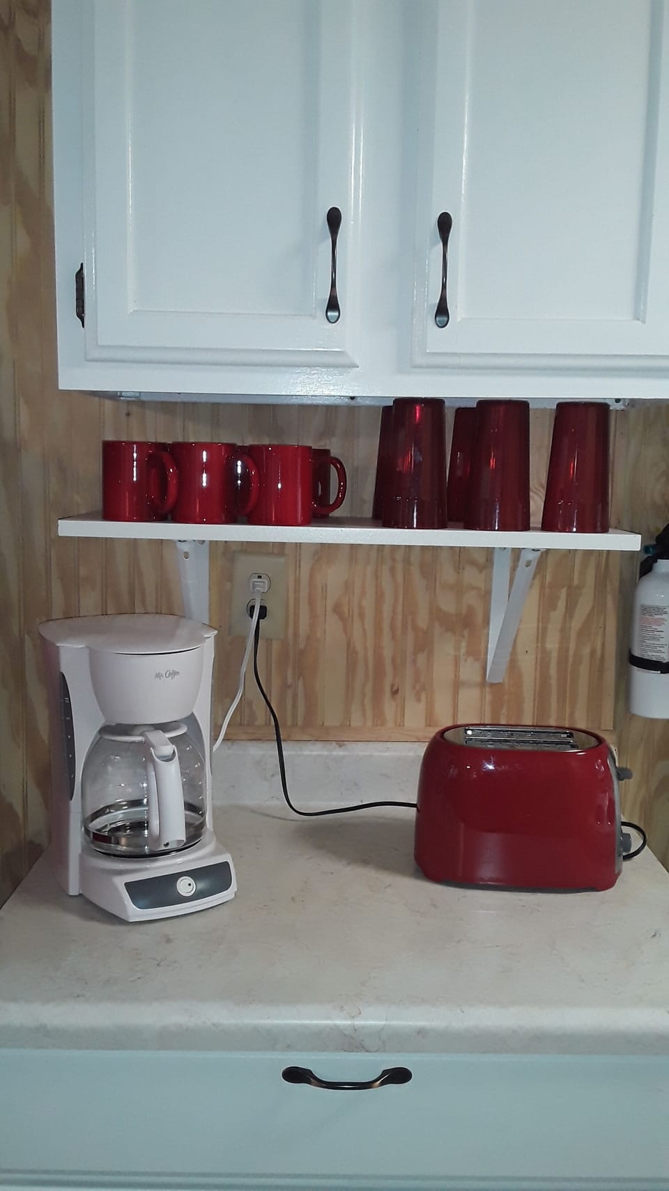 Coffee pot, toaster, coffee mugs, and red glasses.