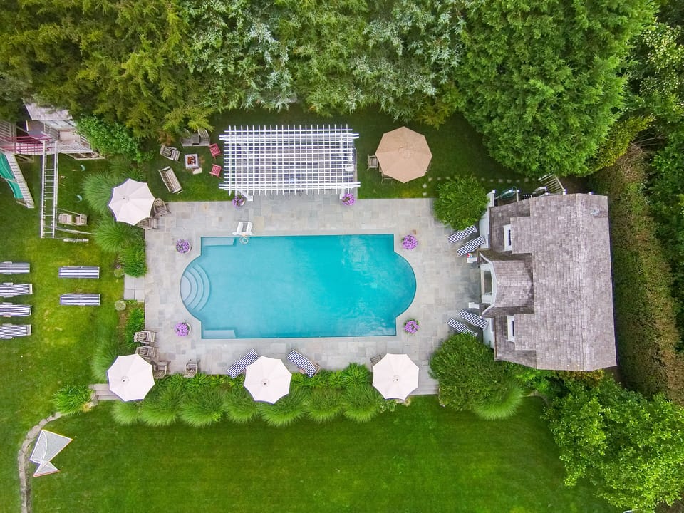 Oversized salt water heated pool w/ pool house; swingset w/tree house; fire pit
