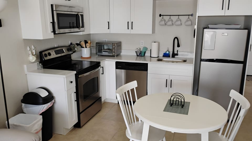 Full Kitchen with full size stove, dishwasher, microwave, refrigerator+ table
