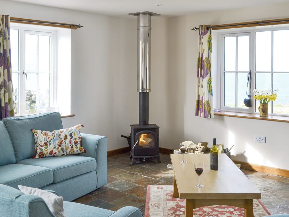Welcoming living area with wood burner | The Old Dye House, Hallin