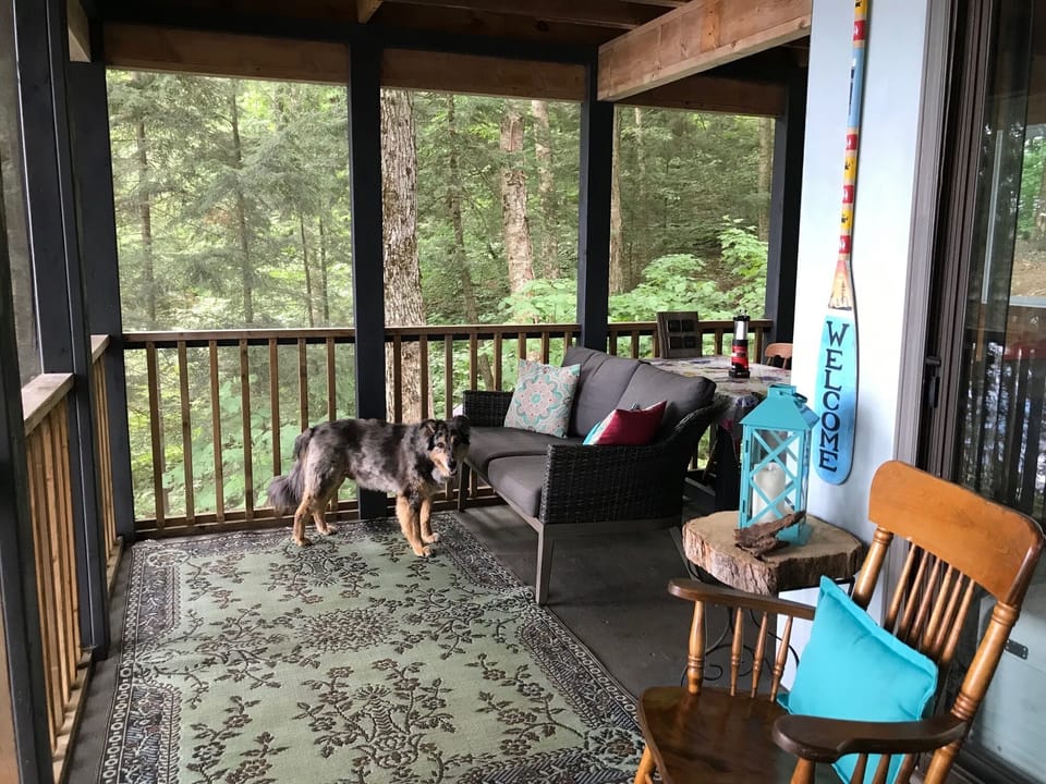Large screened in porch on the cozy cabin.
