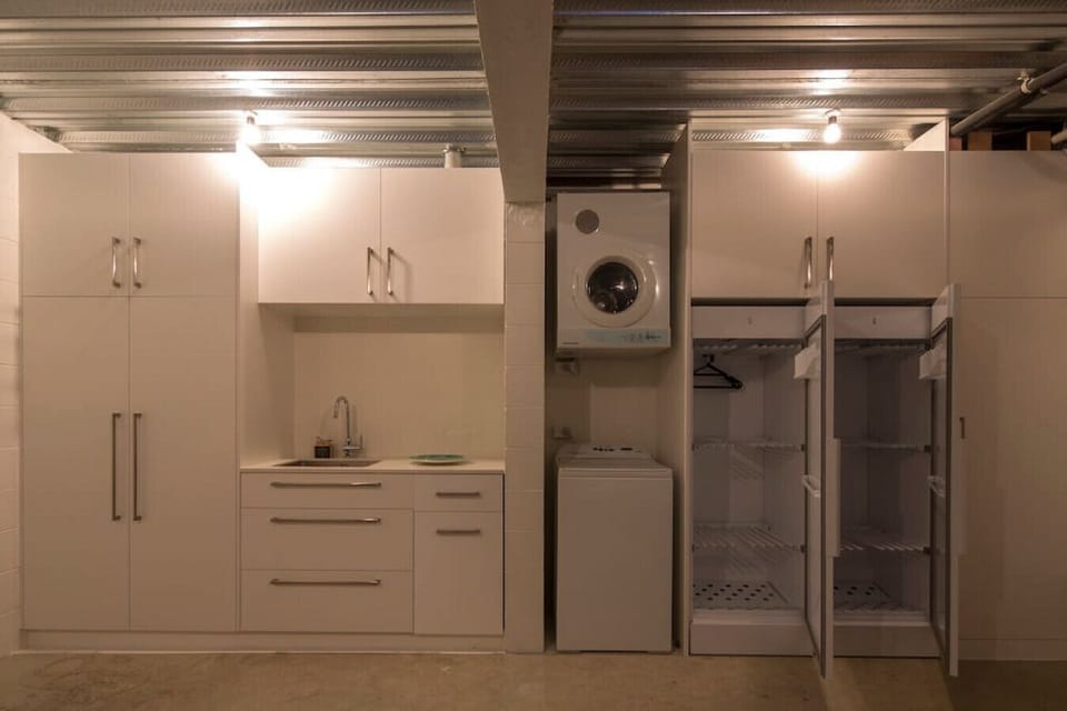 Convenient drying cupboards for wet ski gear and full laundry facilities in the garage