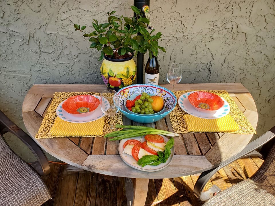 Dine al fresco on your private patio — table, umbrella & tropical views await.”