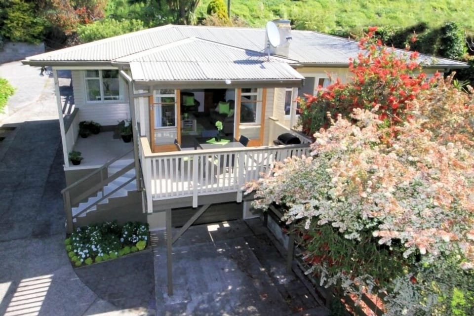 Front of House (sloping driveway on left).
