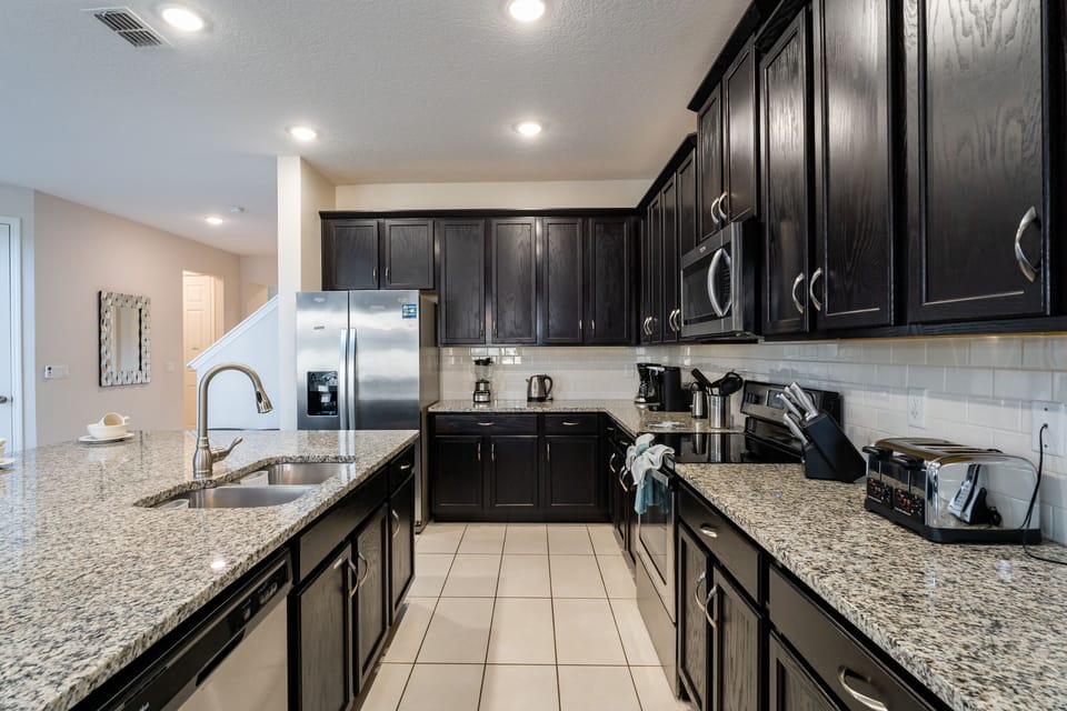 Galley style kitchen with stainless appliances