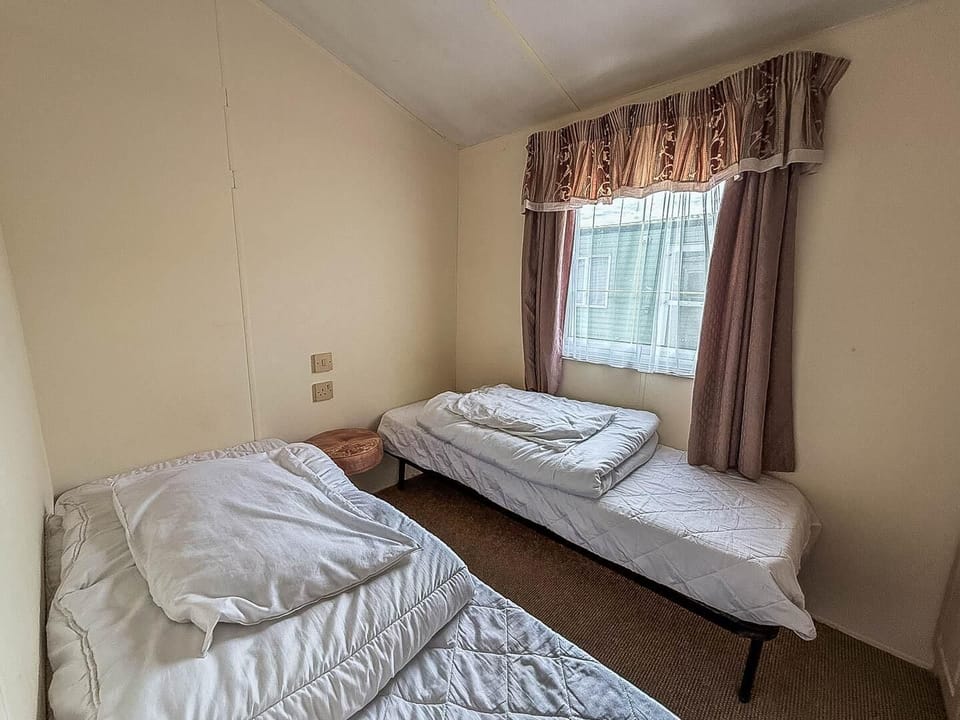 Perfect for family or friends, our classic caravan's twin bedroom offers a cosy and practical space for everyone to rest.
