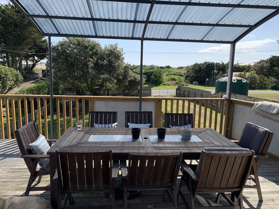 Sunny front deck looking west towards beach access