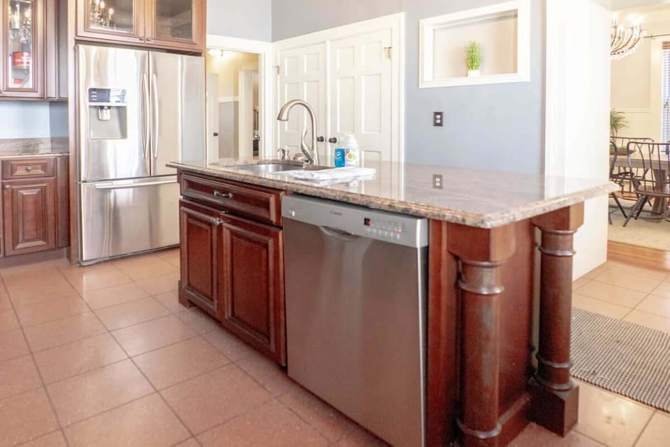 Fully equipped kitchen with stainless appliances and ample counter space for cooking during your stay. #FullKitchen 