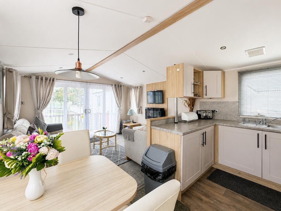 The caravan kitchen is perfect for preparing quick meals before heading out to explore the coast.