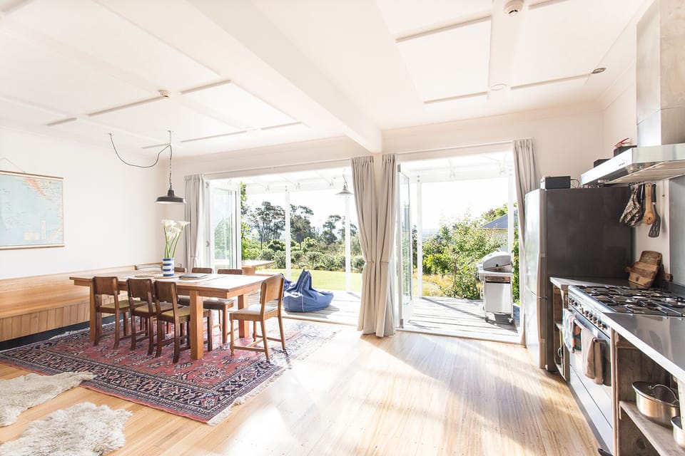 The kitchen/dining area opens onto a sunny verandah