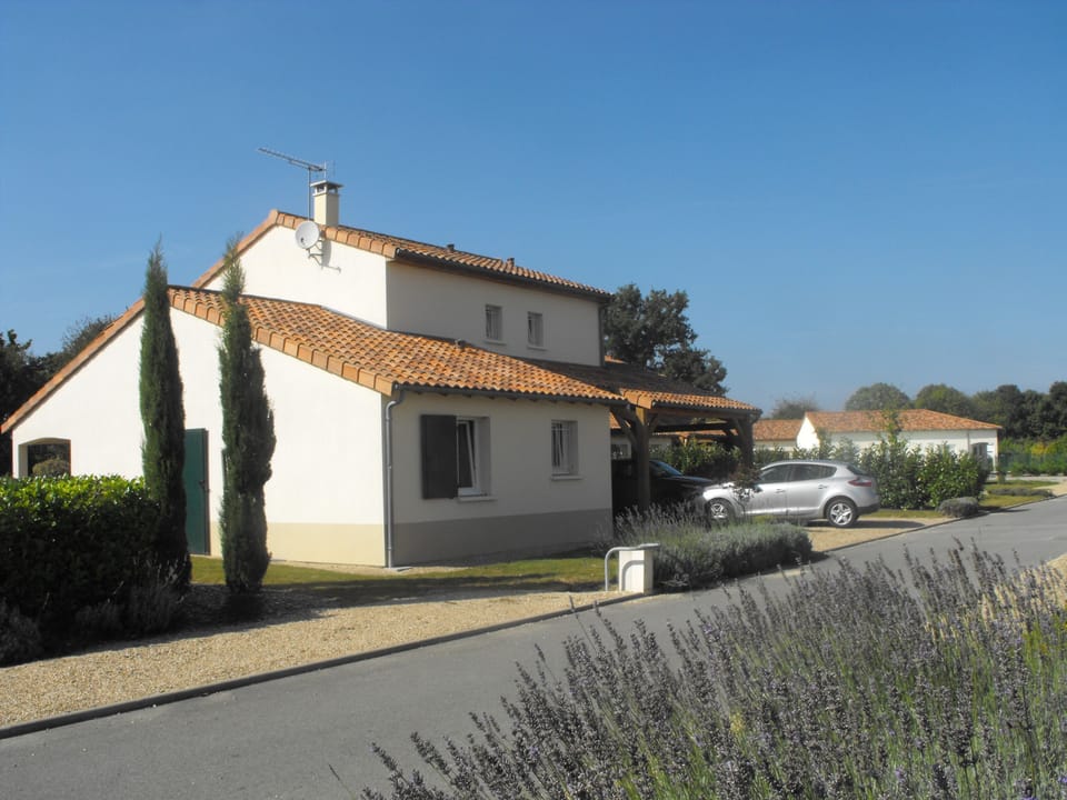 Back side of the house , with carport & extra parking places.