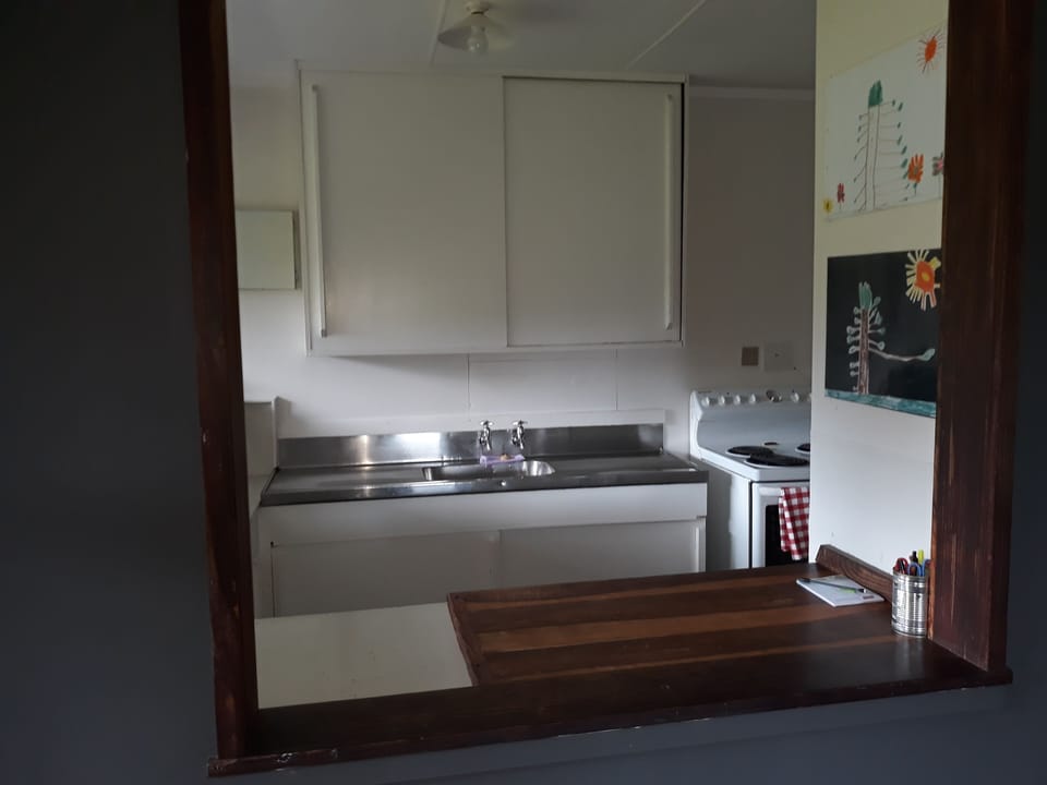 kitchen bench, looks through to living room.