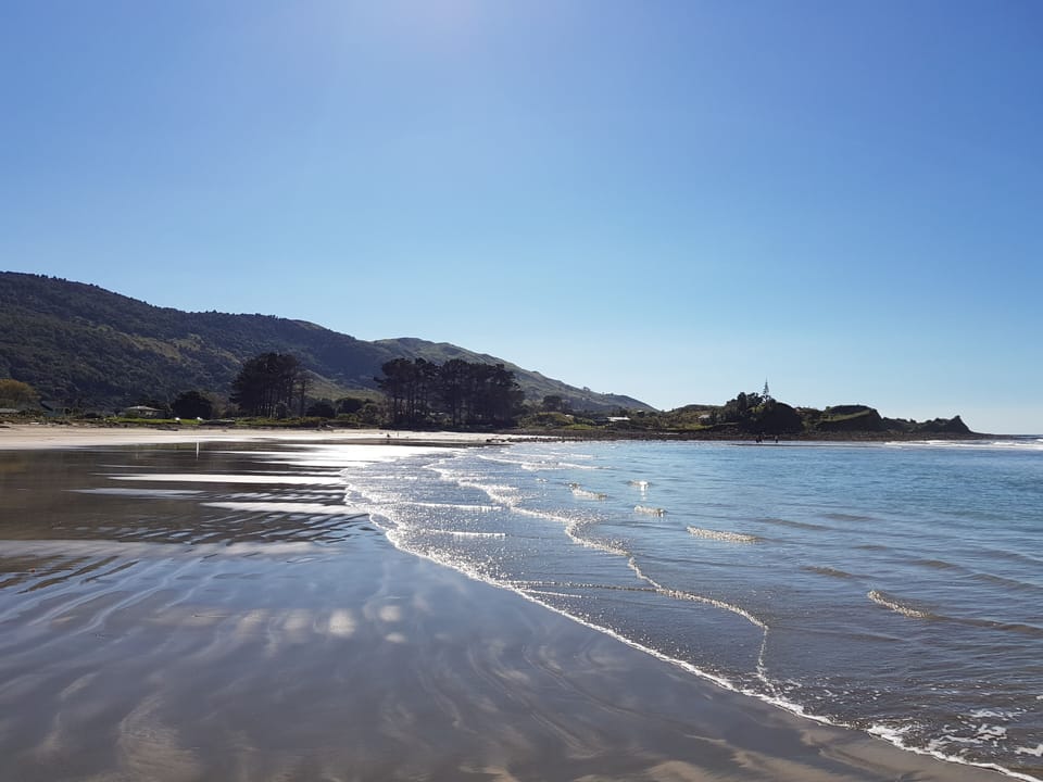 View along beach towards rocks.