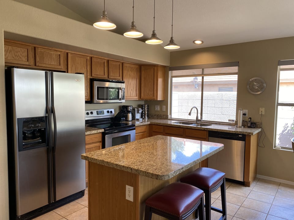 Oak kitchen with stainless steel appliances & large island seating 2