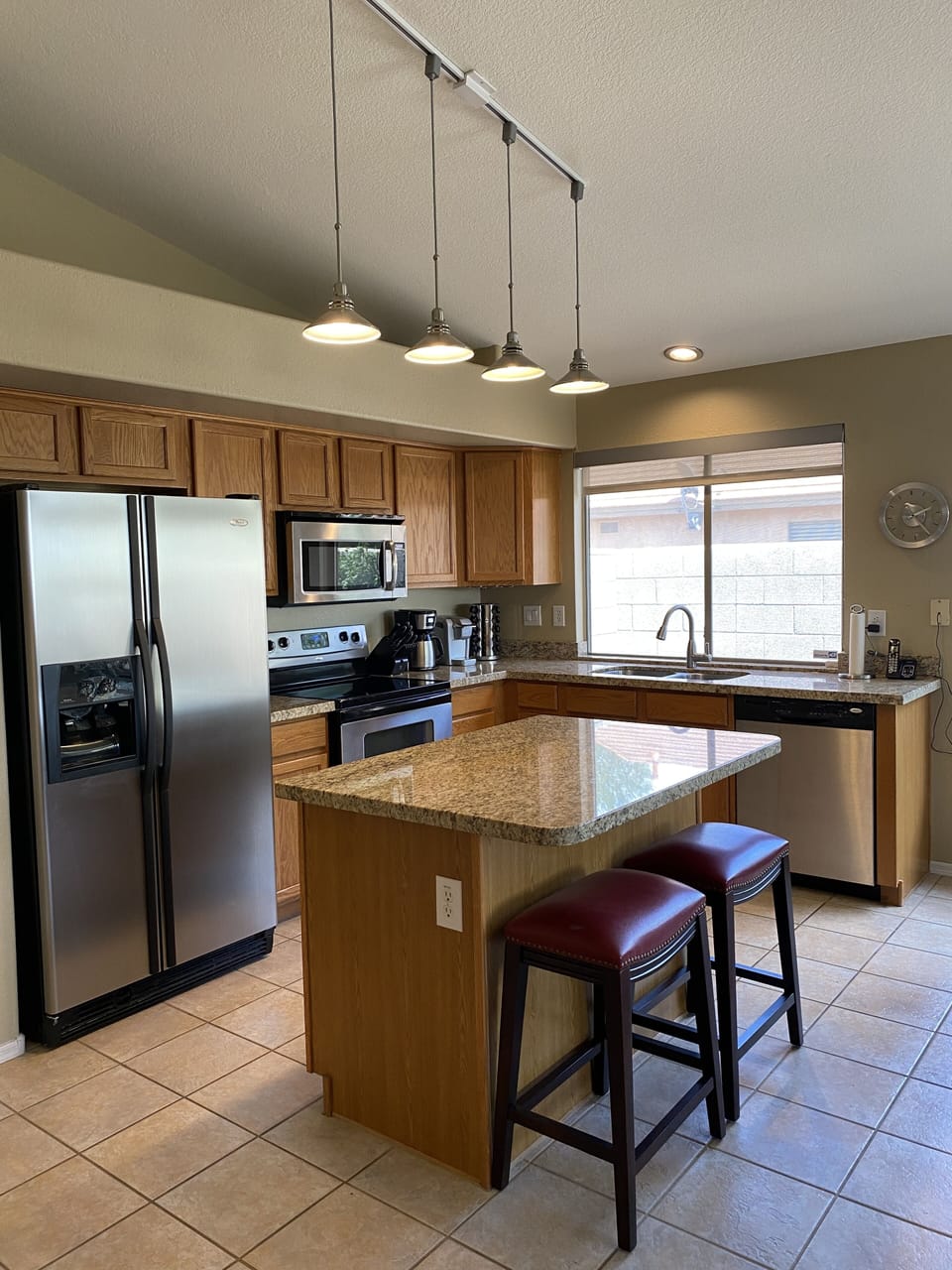 Oak kitchen with stainless steel appliances & large island seating 2