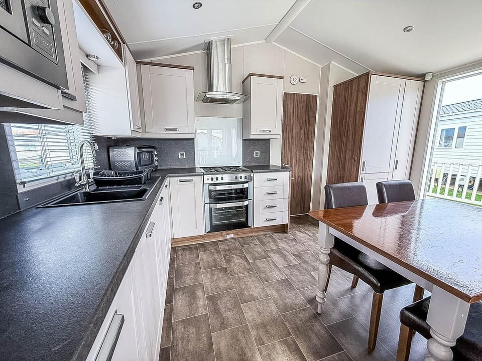 The dining table is perfect for everything from family breakfasts to evening board games, creating an inviting hub for socialising and dining.