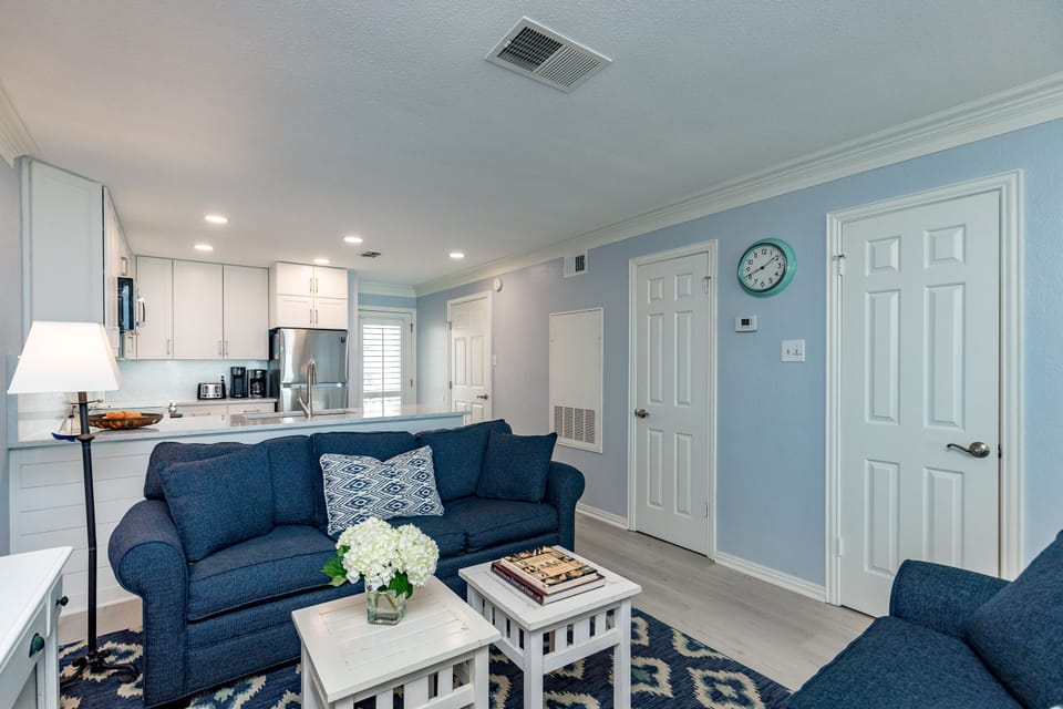 Unwind in your bright, coastal-inspired living space where soothing blue tones and comfortable seating create the perfect retreat after exploring.