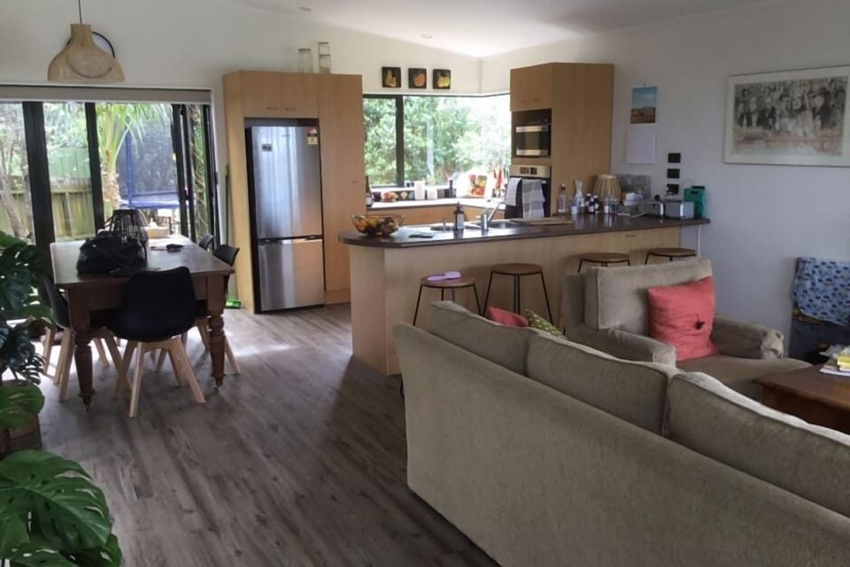 Open plan living, kitchen, dining, opening on to decks