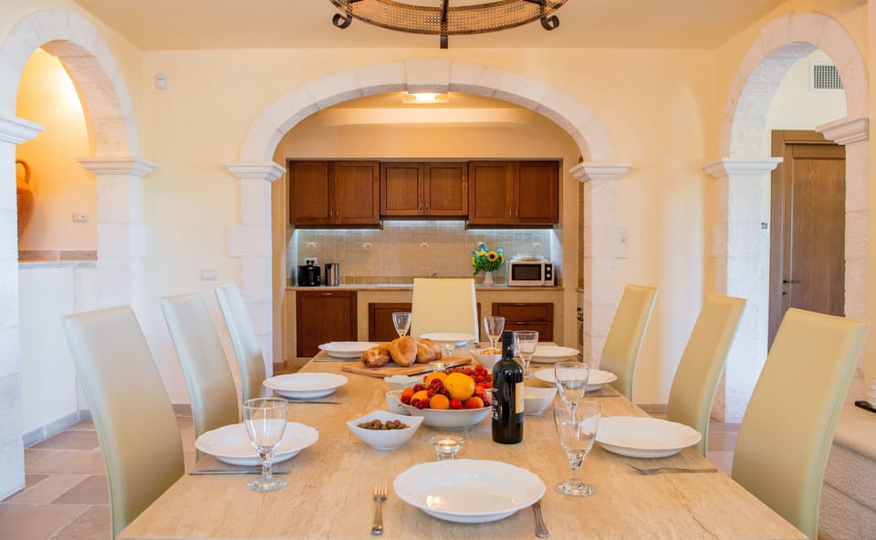 Stone dining table in local stone with Italian leather chairs seating 8 people
