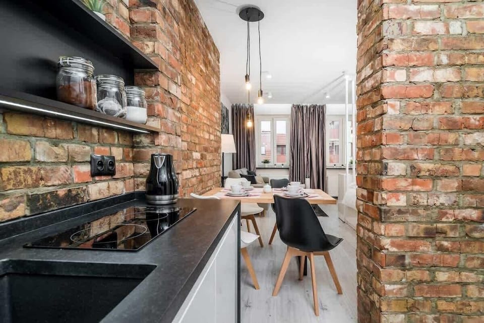 Kitchenette with dishwasher, kettle, stove, sink, oven and cupboards