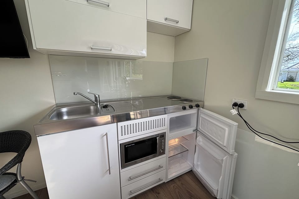 Kitchenette has under bench fridge with separate freezer.