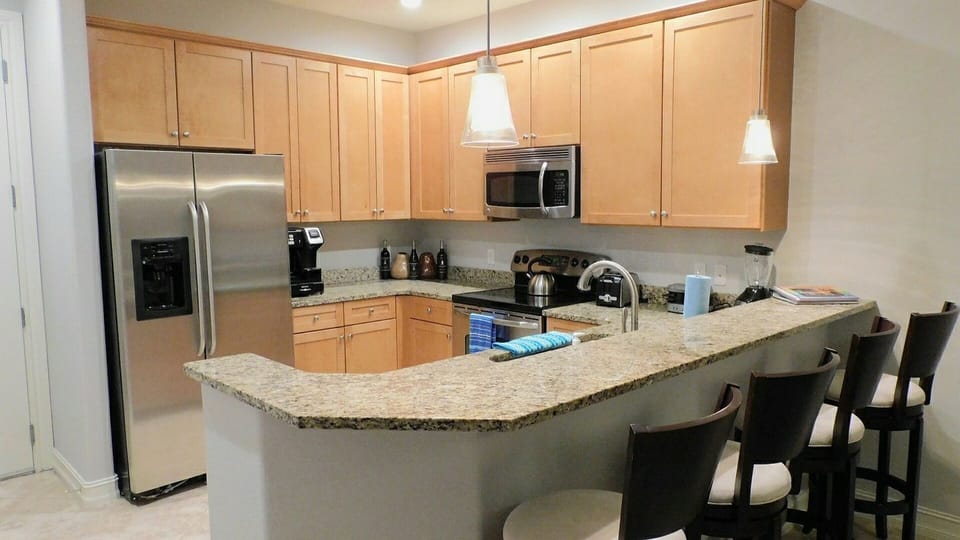 Kitchen with bar area next to dinning room.