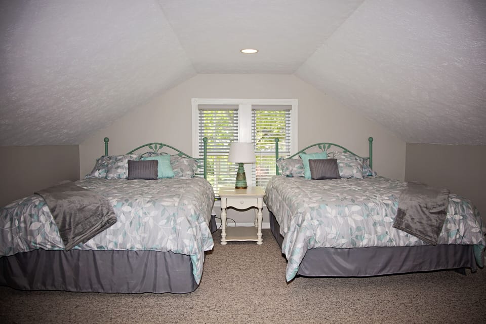Upstairs suite two queen beds with sitting room, full bath and walk in closet