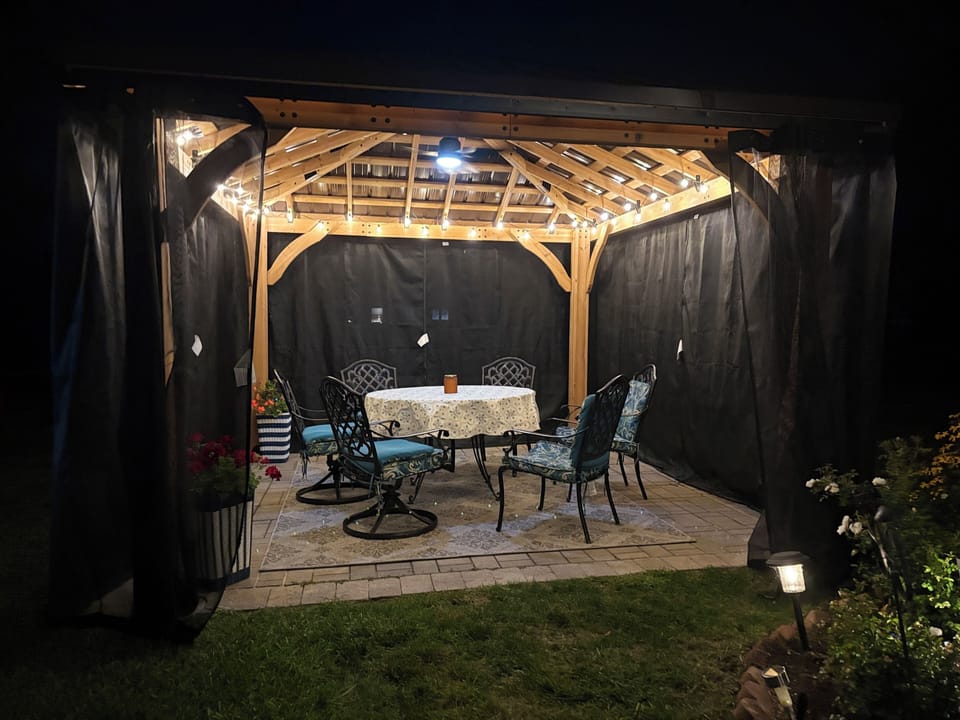 Outdoor gazebo with mosquito netting, lights and fan. Perfect for evenings