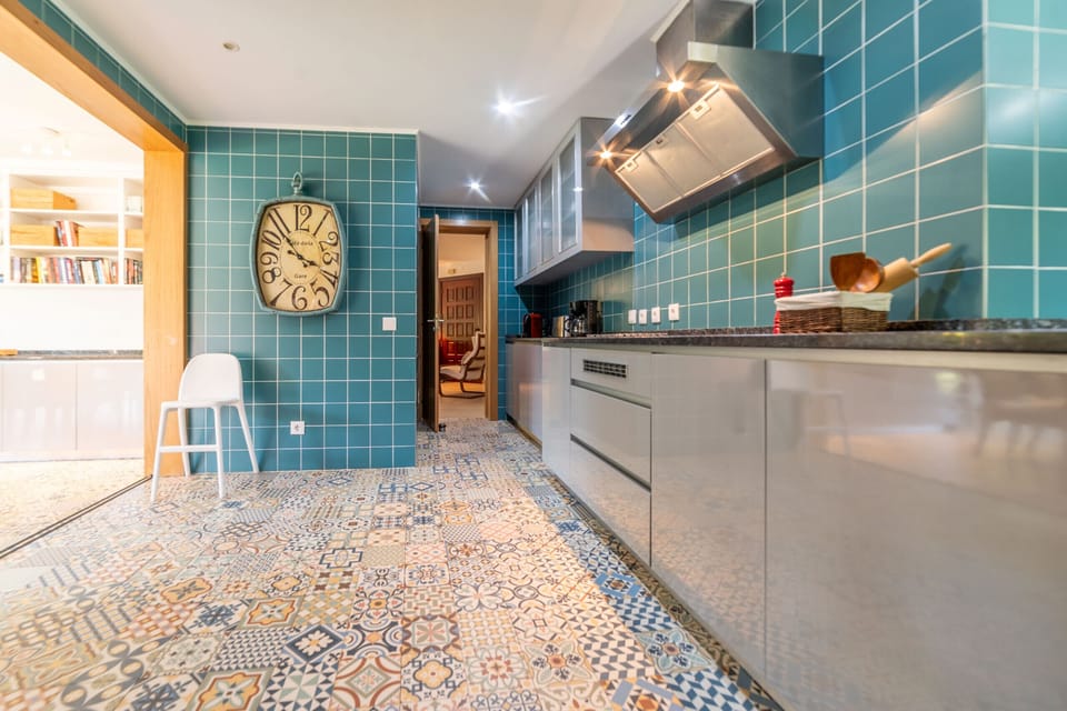 Contemporary turquoise kitchen with patterned floor tiles — Villa das Begonias, holiday villa in Herdade de Aroeira