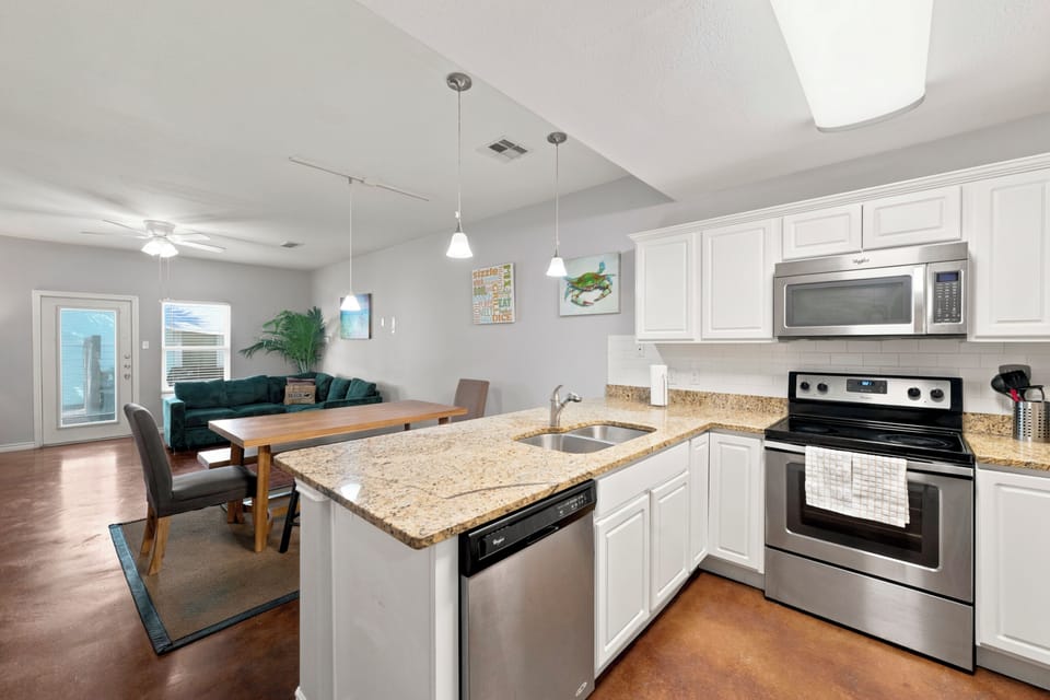 Your open-concept kitchen flows seamlessly into the dining and living areas, complete with granite countertops, stainless appliances, and everything you need to prepare meals and gather with loved ones.