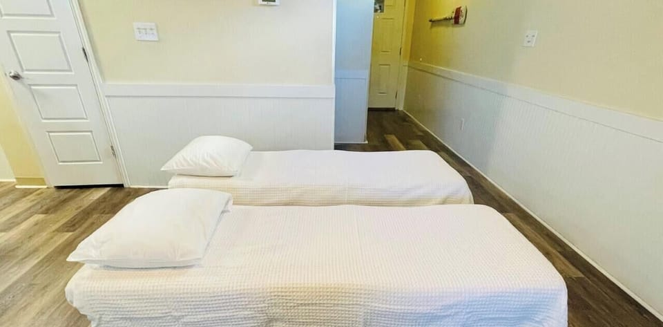 Rest peacefully on your comfortable beds with crisp, fresh linens in this bright, clean room with warm wood floors.