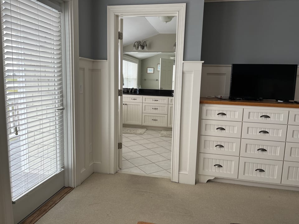 Master Bedroom #1 with view to built-in dresser and large bath.
