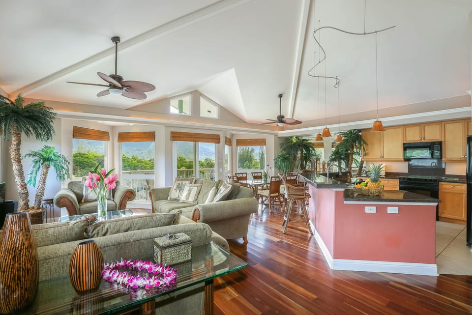 Spacious living area filled with natural light and lush views.