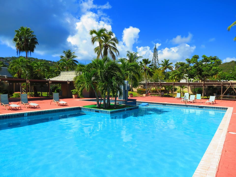 Pineapple Village Pool with complimentary sunlounges and covered areas.