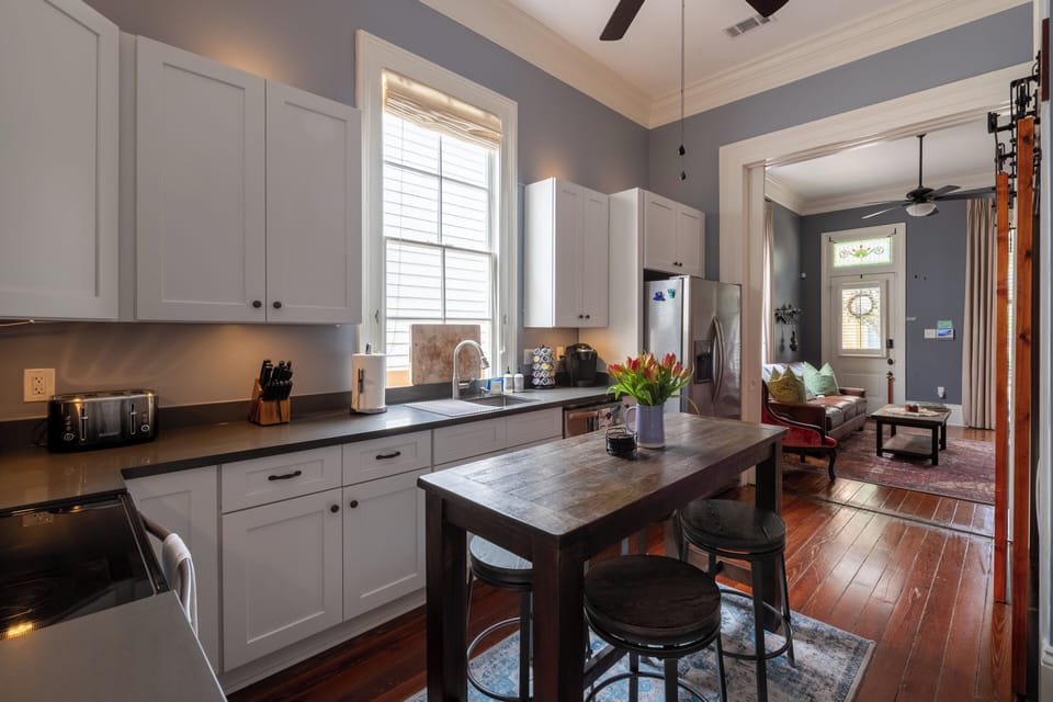Kitchen with dining area, looking into the parlor