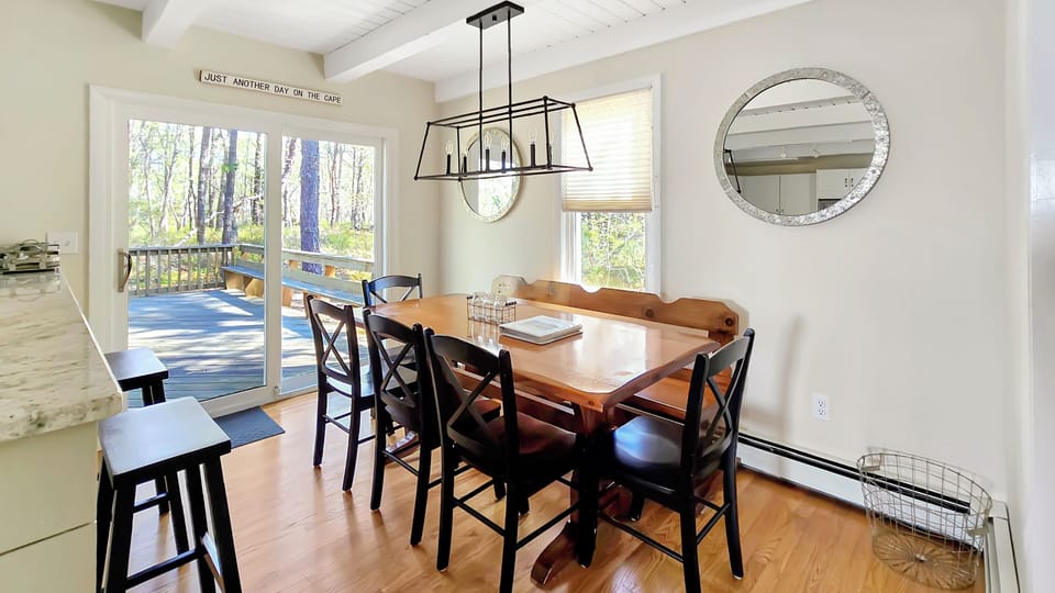 Dining area with large table and slider to back deck