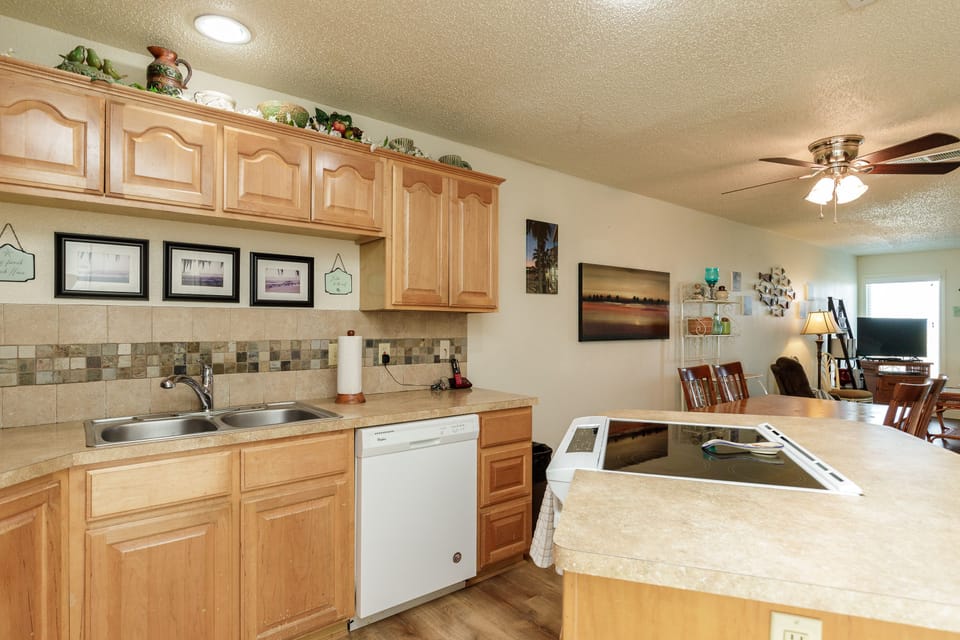 Your fully equipped kitchen features warm wood cabinets, granite countertops, and modern appliances for preparing memorable vacation meals together.