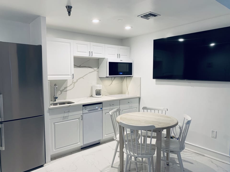 the kitchen fully equipped with refrigerator  dishwasher stove microwave coffema