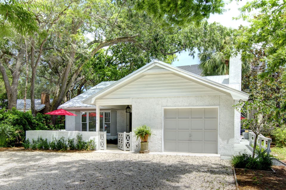 Sea Glass Cottage Exterior And Parking - Arrival view with the garage and driveway parking for up to three cars, set 300 feet from the ocean on Ocean Boulevard.