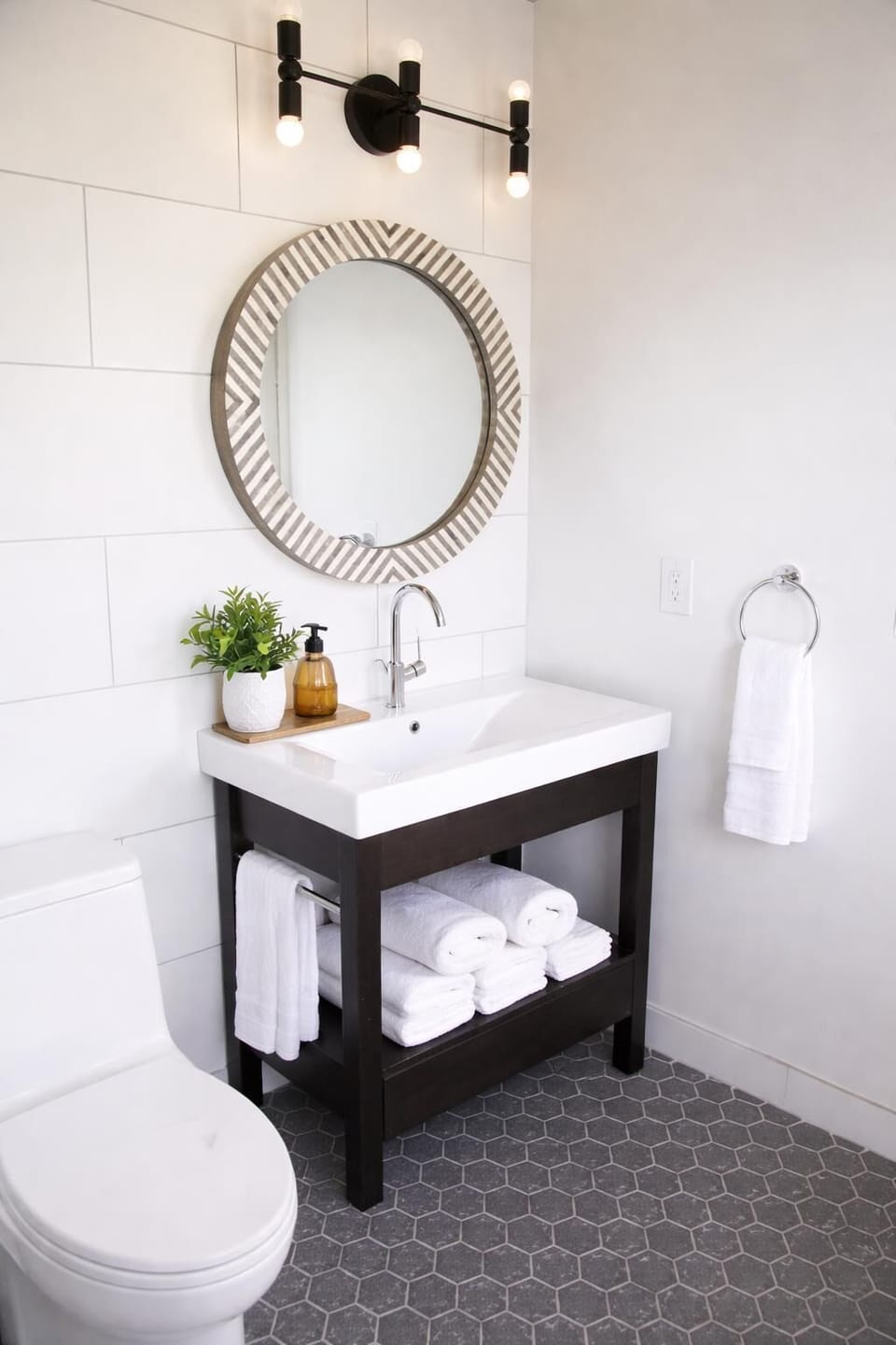 Bright bathroom with modern vanity and round mirror