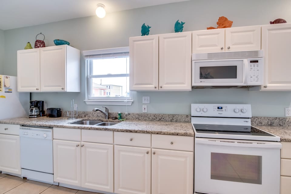 Kitchen - The spacious kitchen is fully stocked with dishes, cookware, glassware, pot & pans...basically all you could need to prepare your meals on site