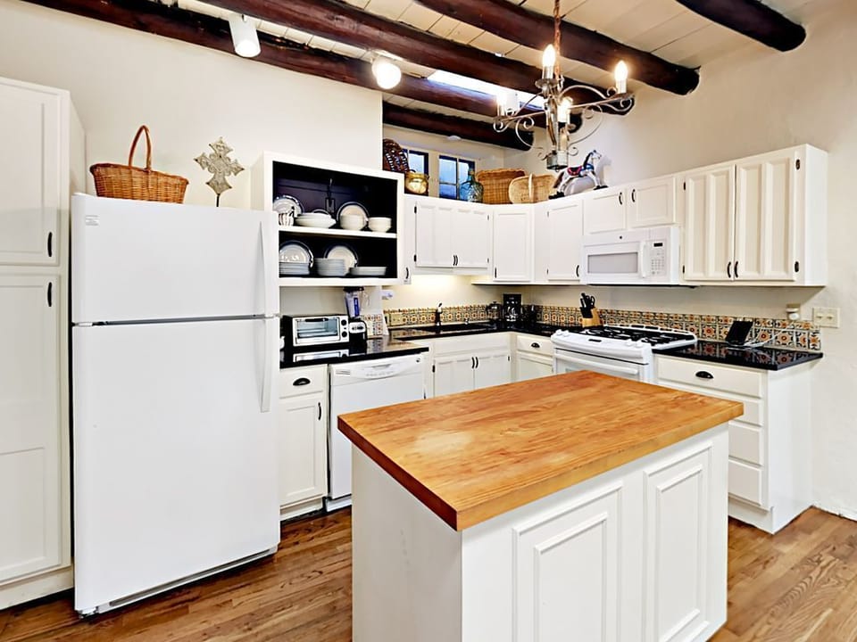 The home's modern kitchen features quartz countertops and artisan tile work.