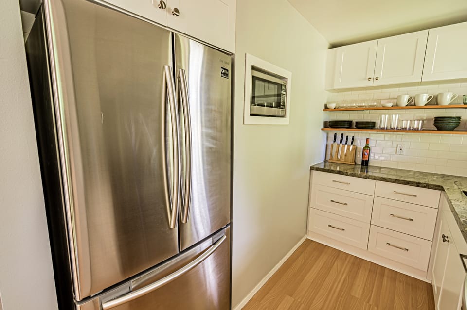 Ample sized refrigerator and microwave, but tucked out of the way.