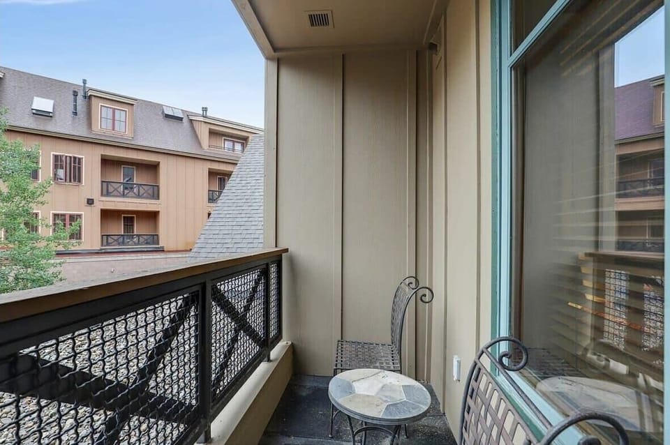 The view from the private balcony, which is outfitted with a patio table and two chairs.